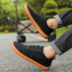 Black Mens Urban barefoot shoes with an orange sole. These casual shoes have maximum comfort with wide toe.