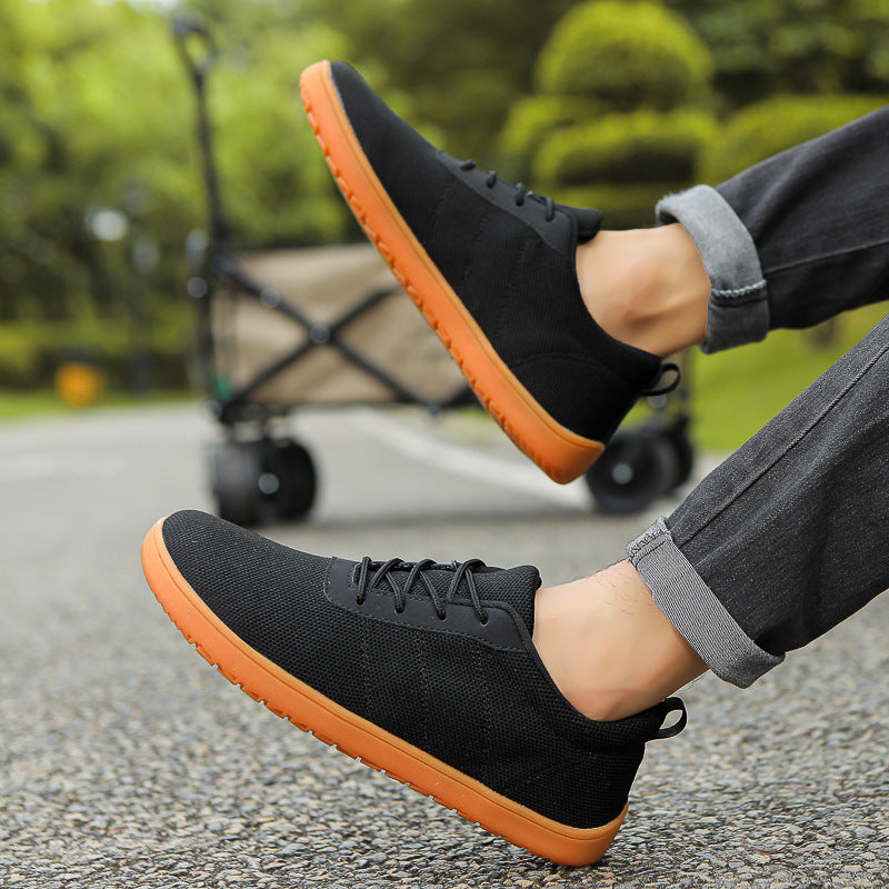 Black Mens Urban barefoot shoes with an orange sole. These casual shoes have maximum comfort with wide toe.