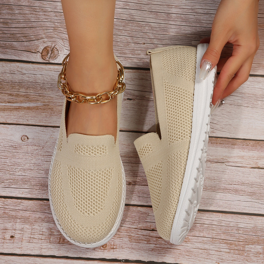 Beige slip on shoes with white soles. These ladies loafers come high in quality.