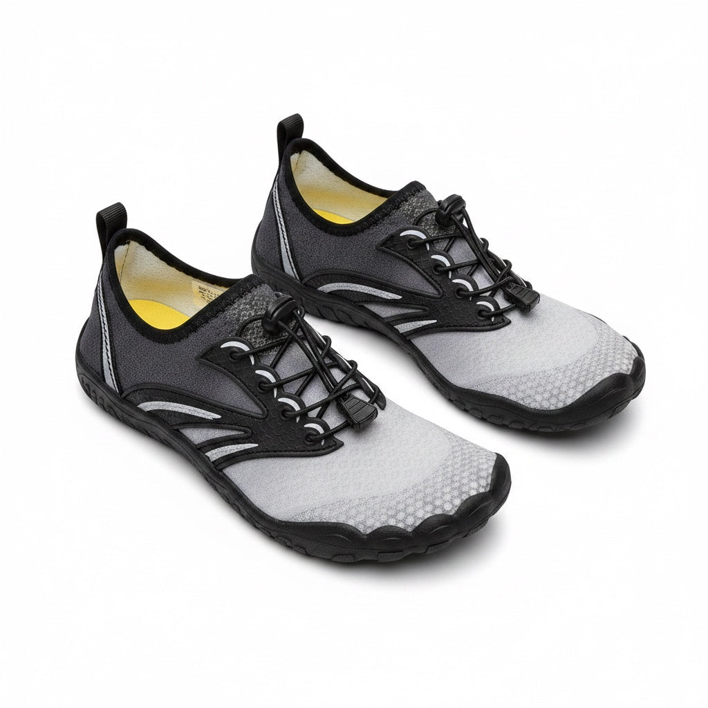 Grey barefoot shoes with black laces and rubber sole. Wide toe for natural movement.