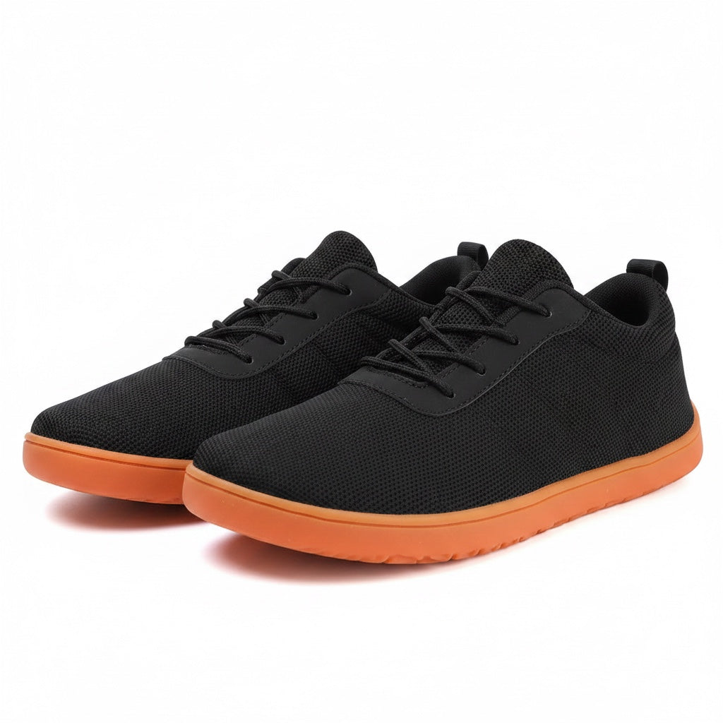 Casual black Urban barefoot shoes with an orange sole. Wide toe for natural comfort. knit finish for added quality.