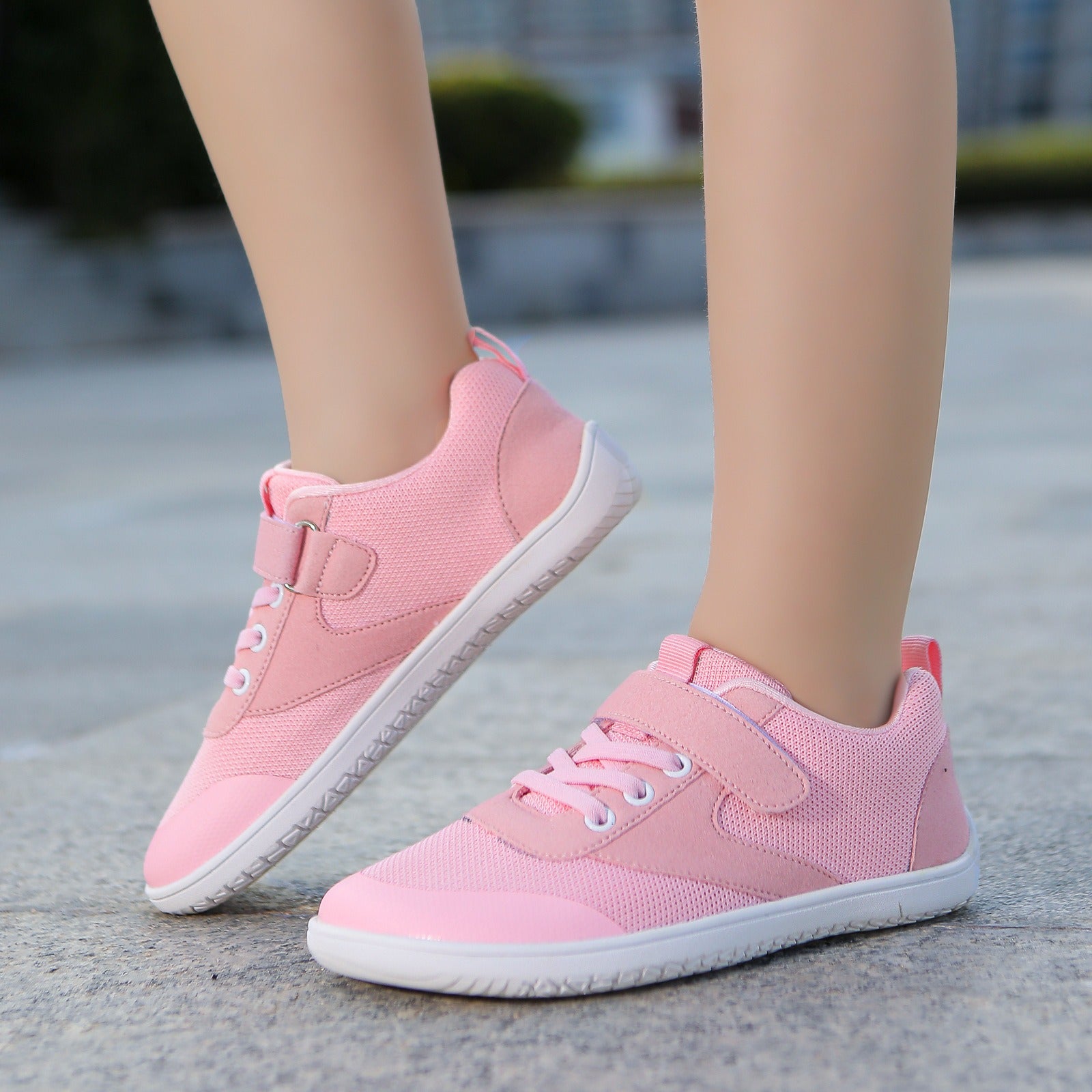 Pink children's  barefoot shoes with white soles. These Sprint barefoot shoes have wide toe for natural movement.